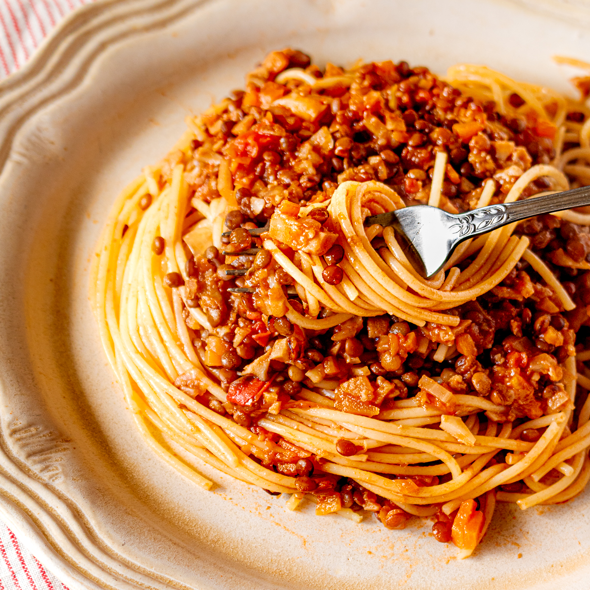 Vegan spaghetti bolognese with lentils served on a plate