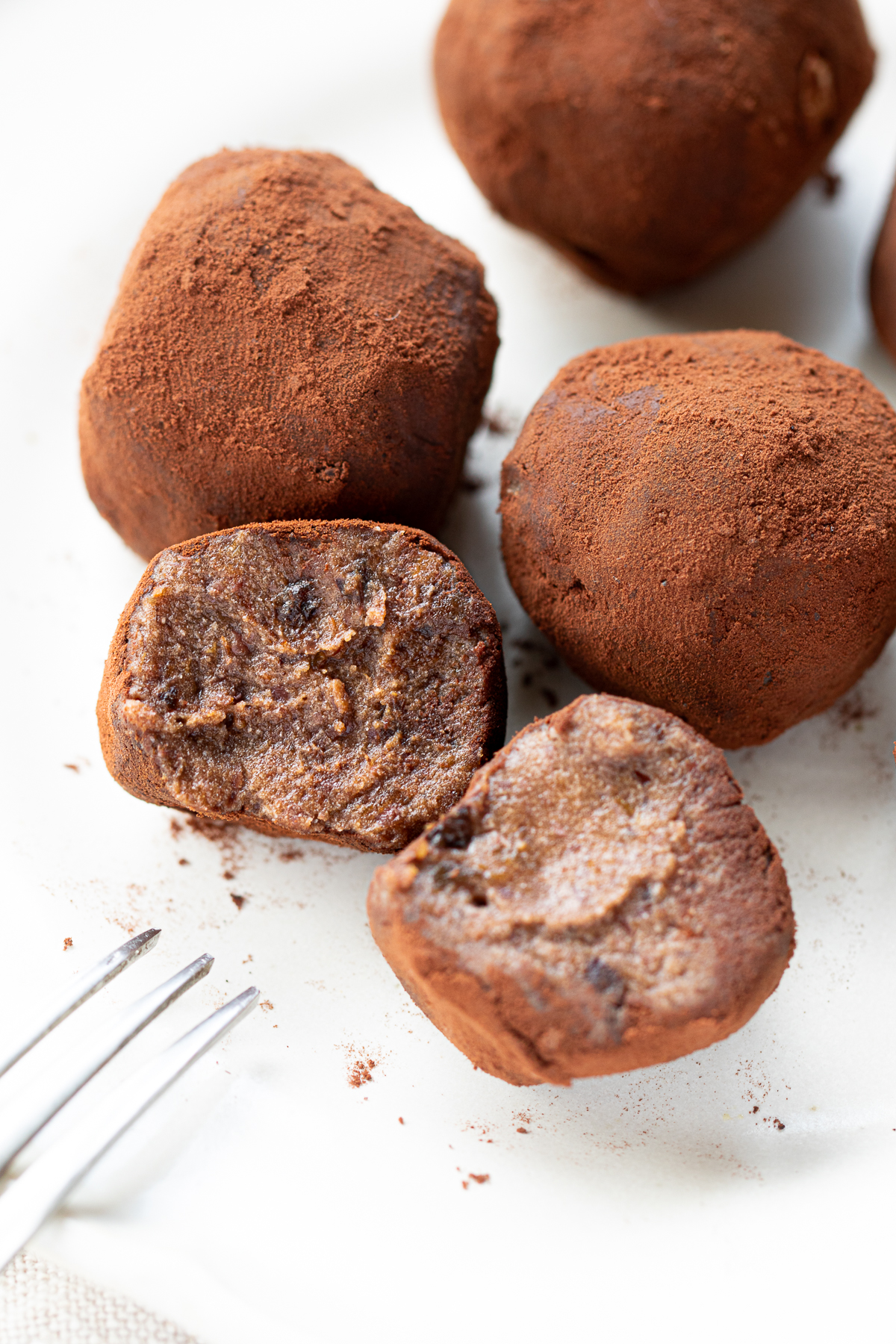 Cross-section of a vegan adzuki bean truffle with rum raisins showing the soft interior
