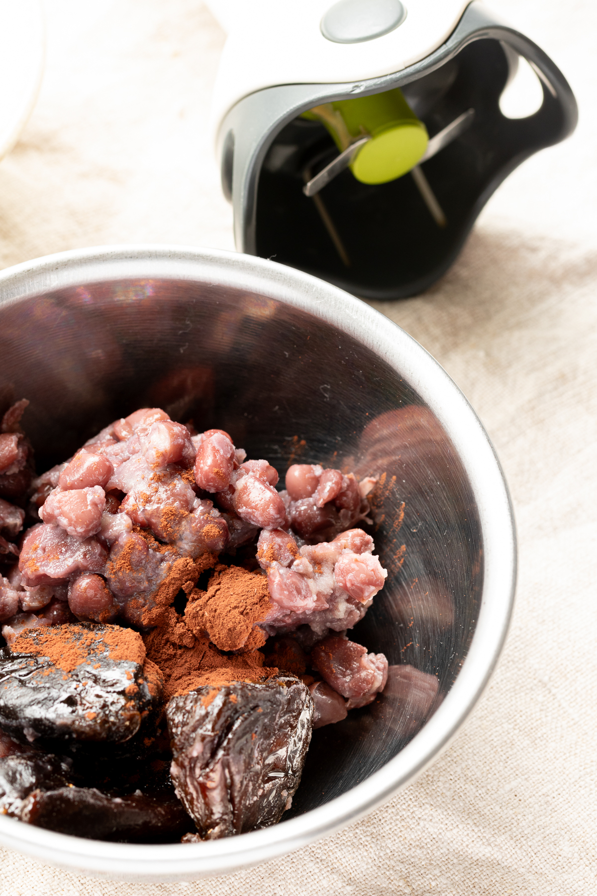 Blending adzuki beans, prunes, and cocoa powder with a hand blender