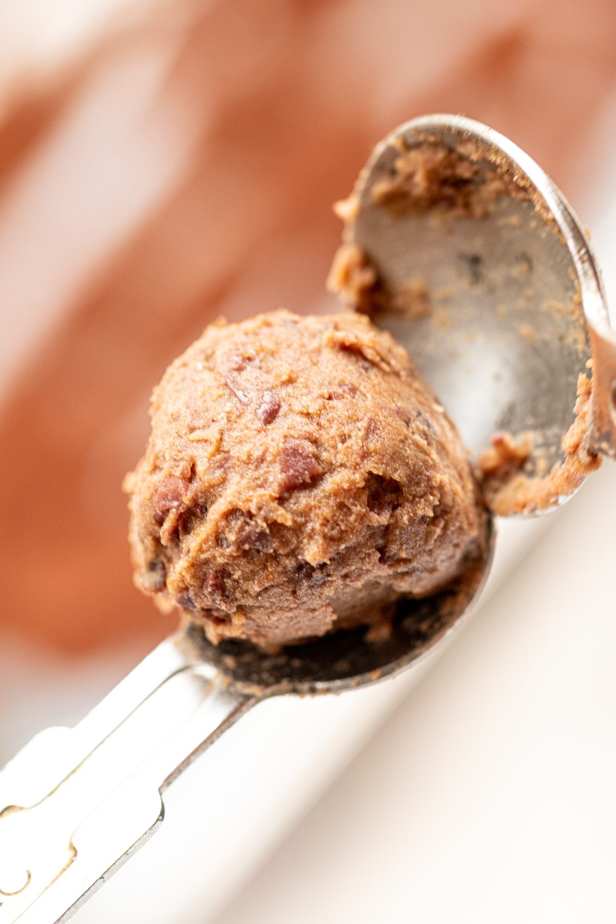 Shaping adzuki bean vegan chocolate truffle mixture into balls using two spoons