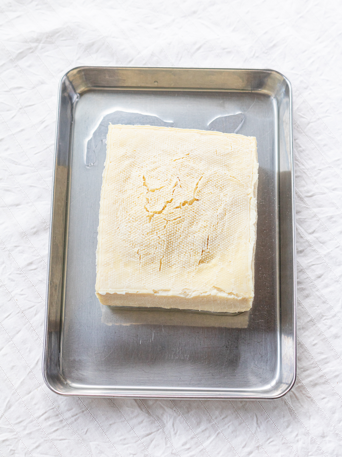 Thawed frozen cotton (momen) tofu on a tray