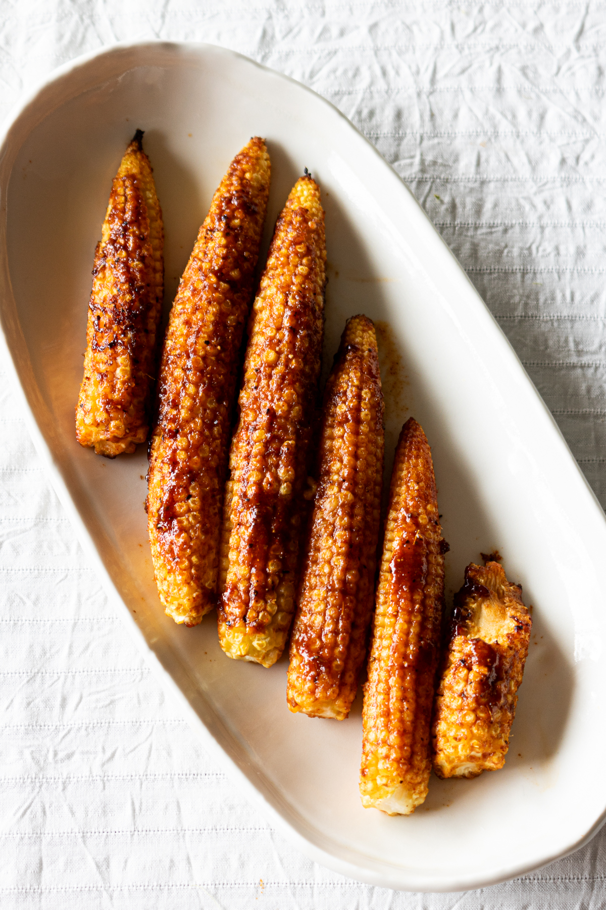 Grilled young corn served as a vegan appetizer or snack