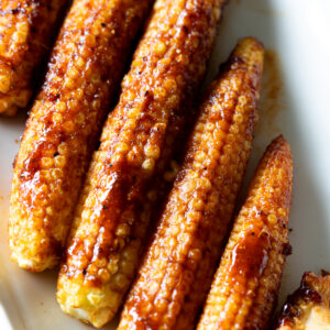 Oven-roasted baby corn with spicy BBQ marinade, vegan recipe