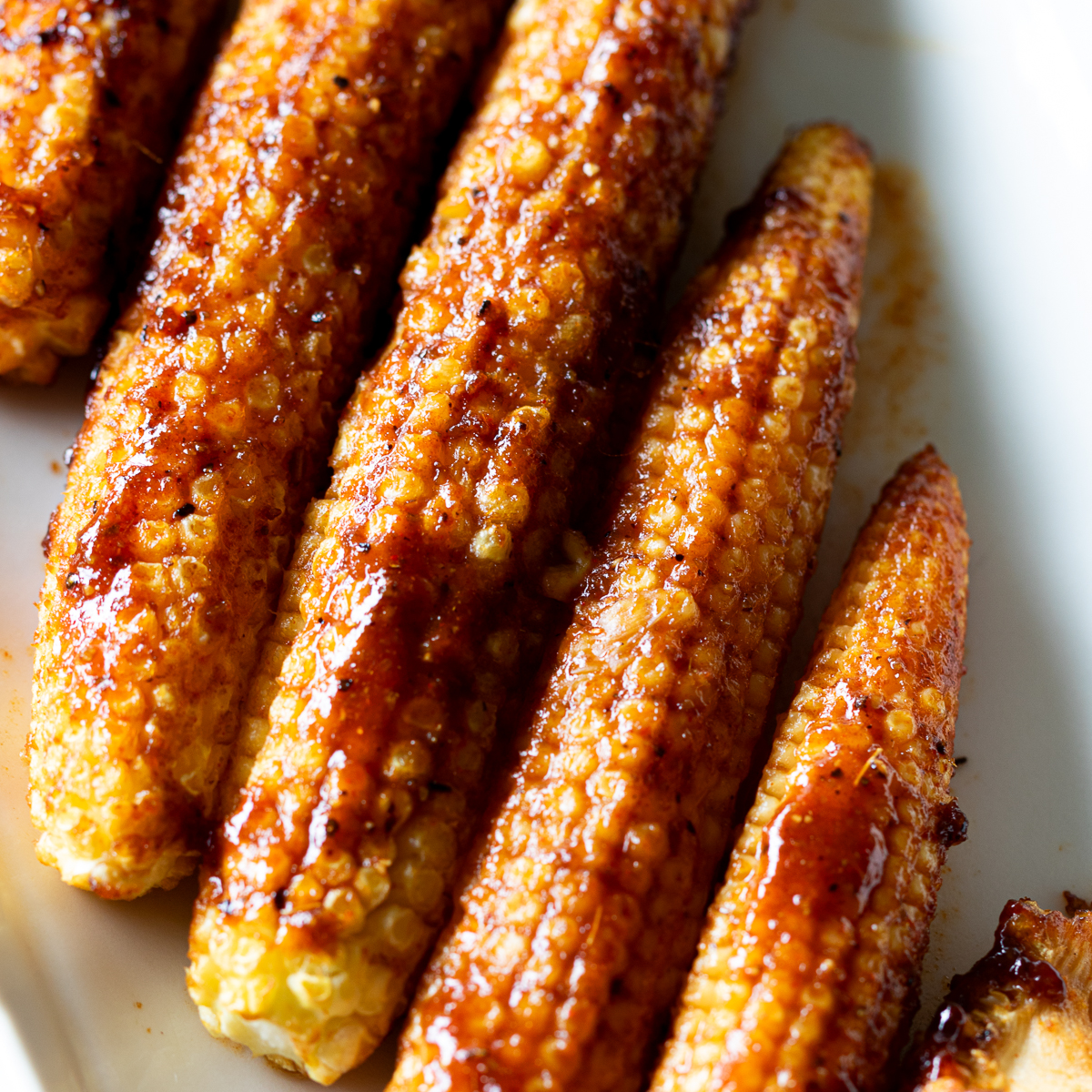 Oven-roasted baby corn with spicy BBQ marinade, vegan recipe