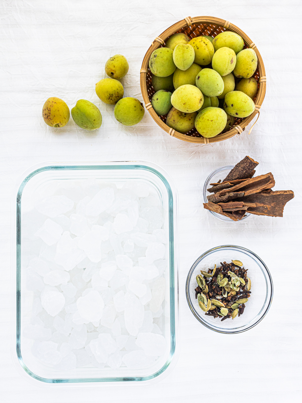 Green ume plums, rock sugar, cinnamon sticks, cloves, and cardamom pods