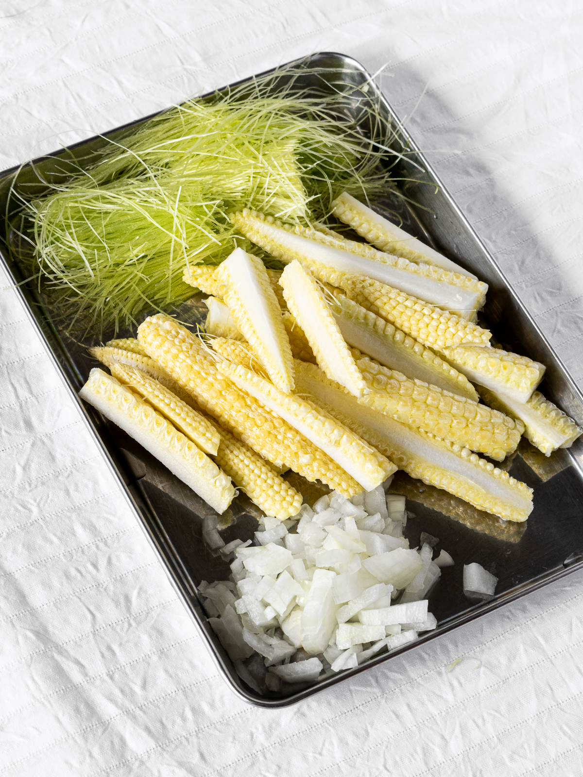 Young corn cut into easy-to-eat lengths, coarsely chopped onions.