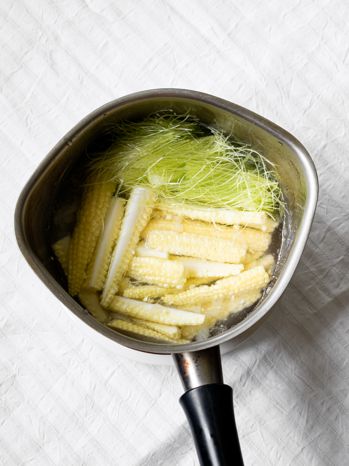 Young corn soup before boiling with water and seasonings