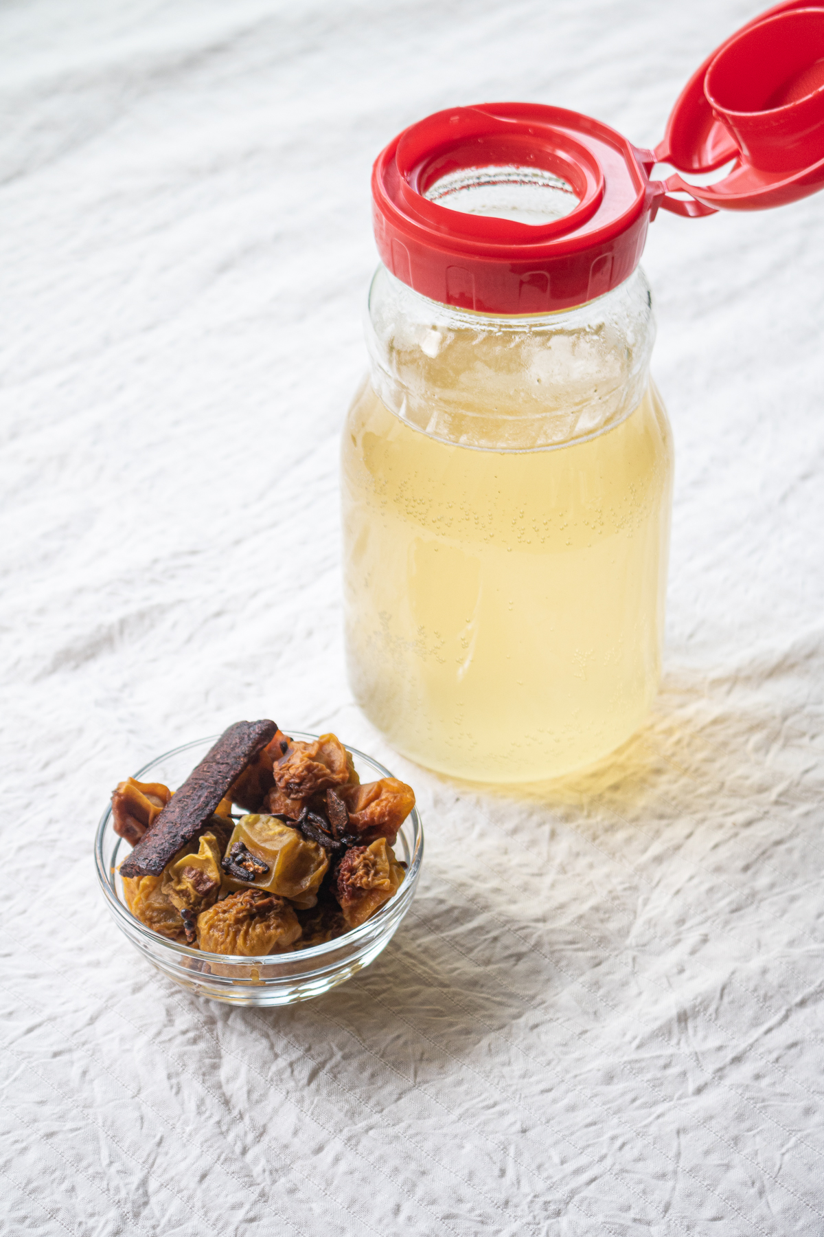 Bottled chai plum syrup and leftover plums used for jam