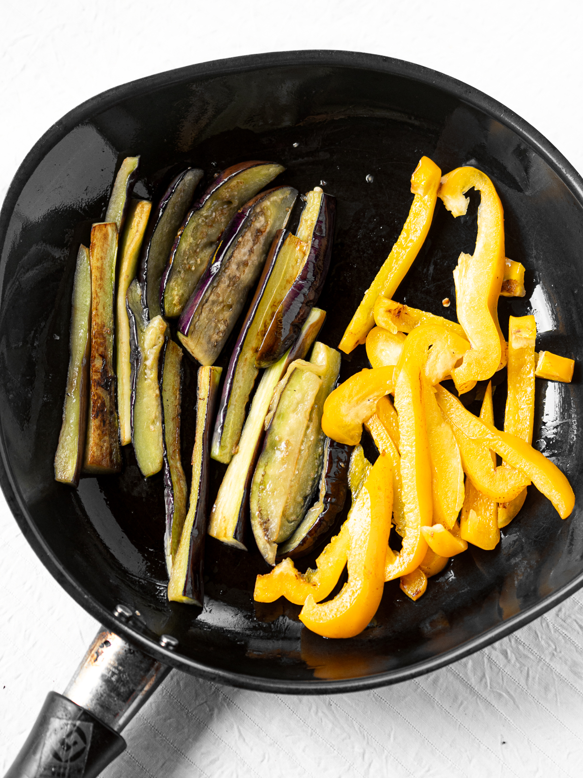 Eggplant wedges and bell peppers sautéed until tender