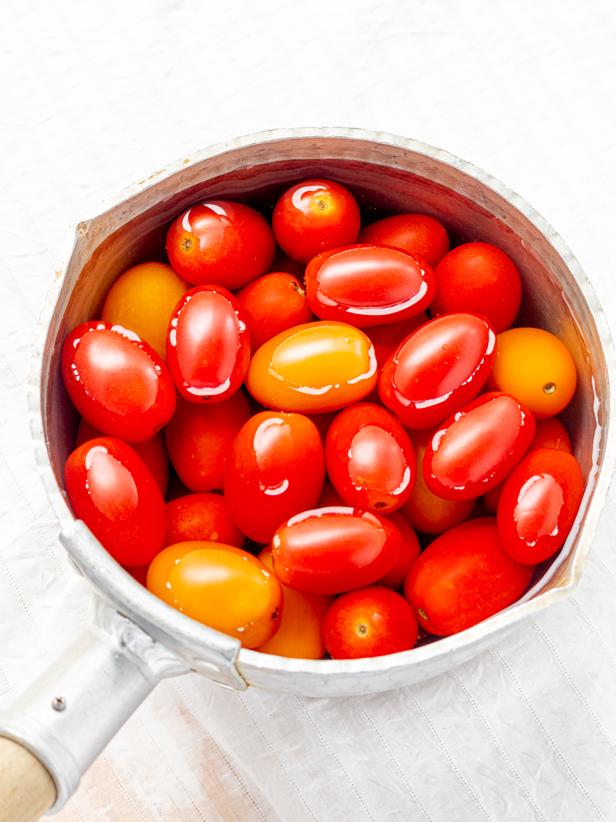 Cherry Tomatoes Soaking in Hot Water – Step 1 for Easy Peeling