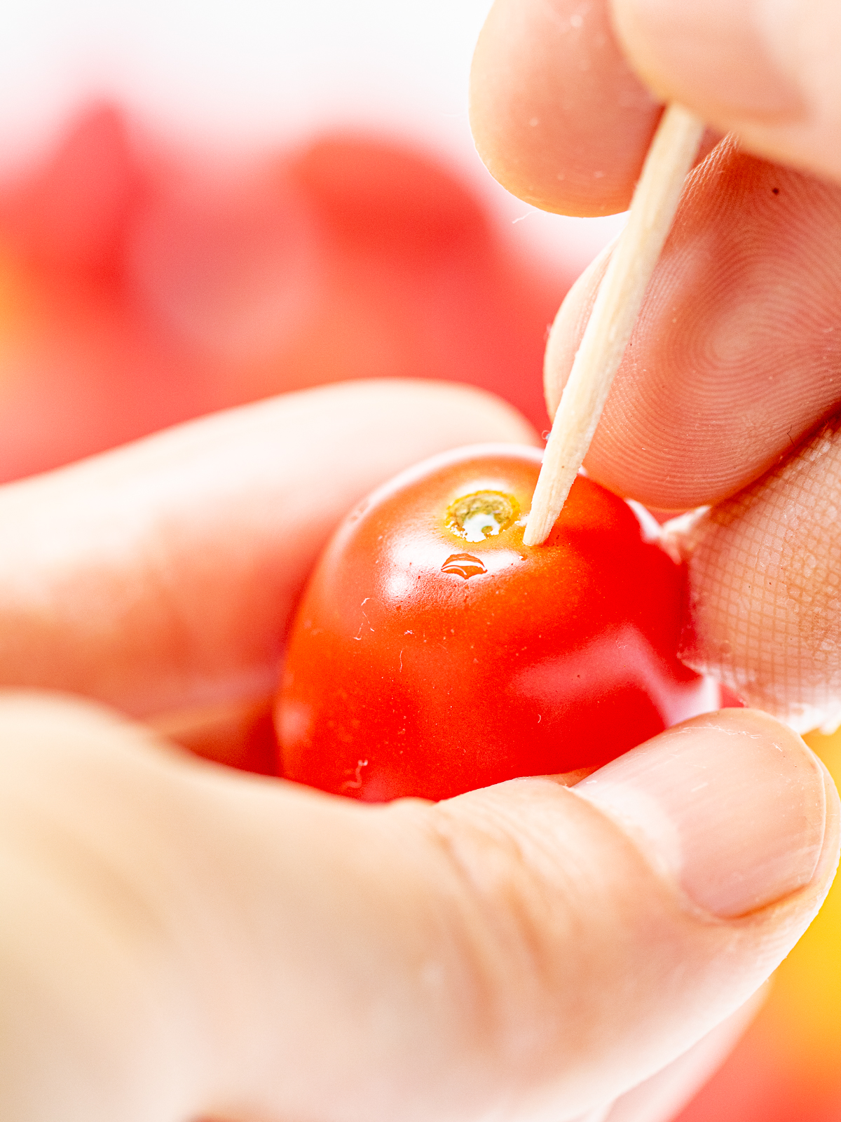 Using a Toothpick to Start Peeling Cherry Tomatoes – No Scoring Needed