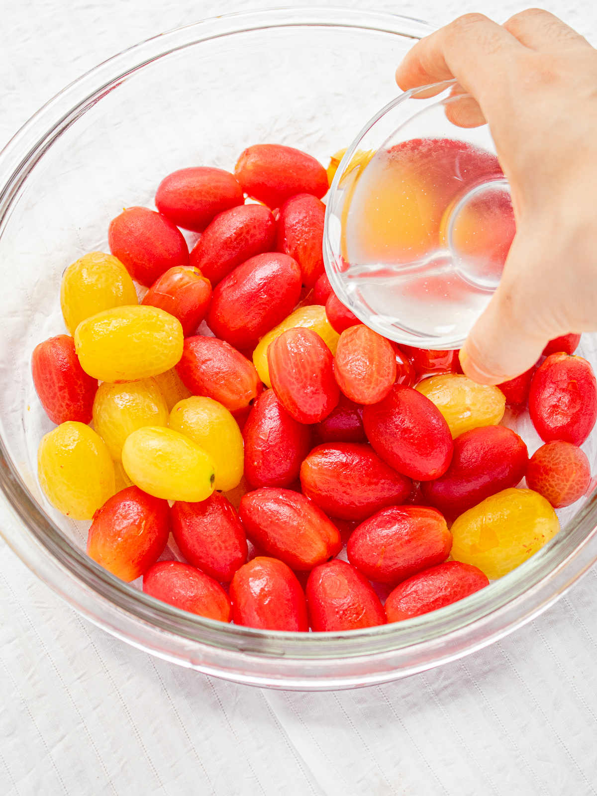 Pouring Plum Syrup over Peeled Cherry Tomatoes – Vegan Summer Recipe Step