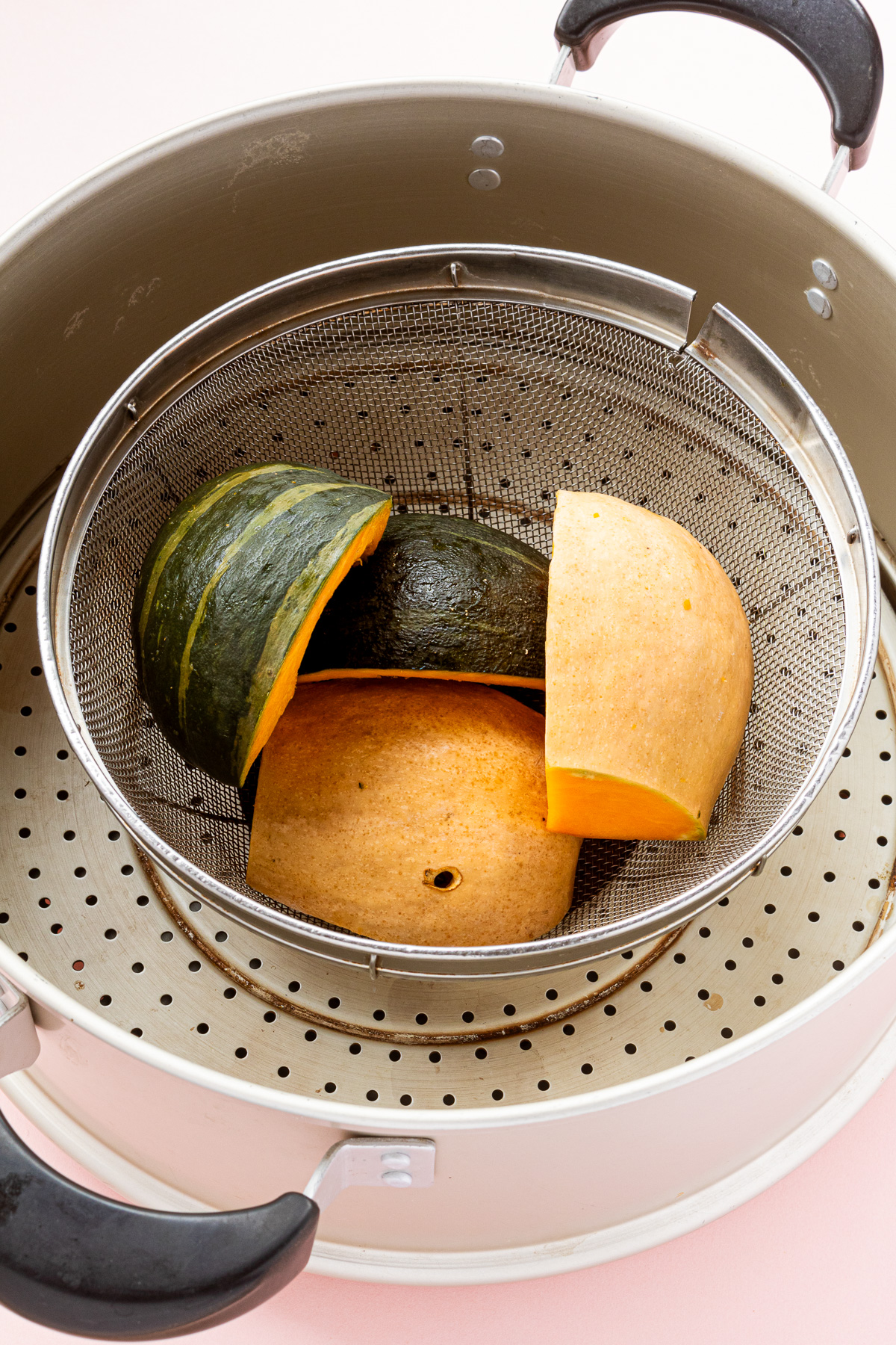 Kabocha squash placed skin-side down in a steamer — cooking tip for vegan recipes