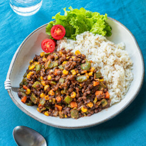Easy vegan stir fry with colorful vegetables and whole red lentils in ketchup-based sauce