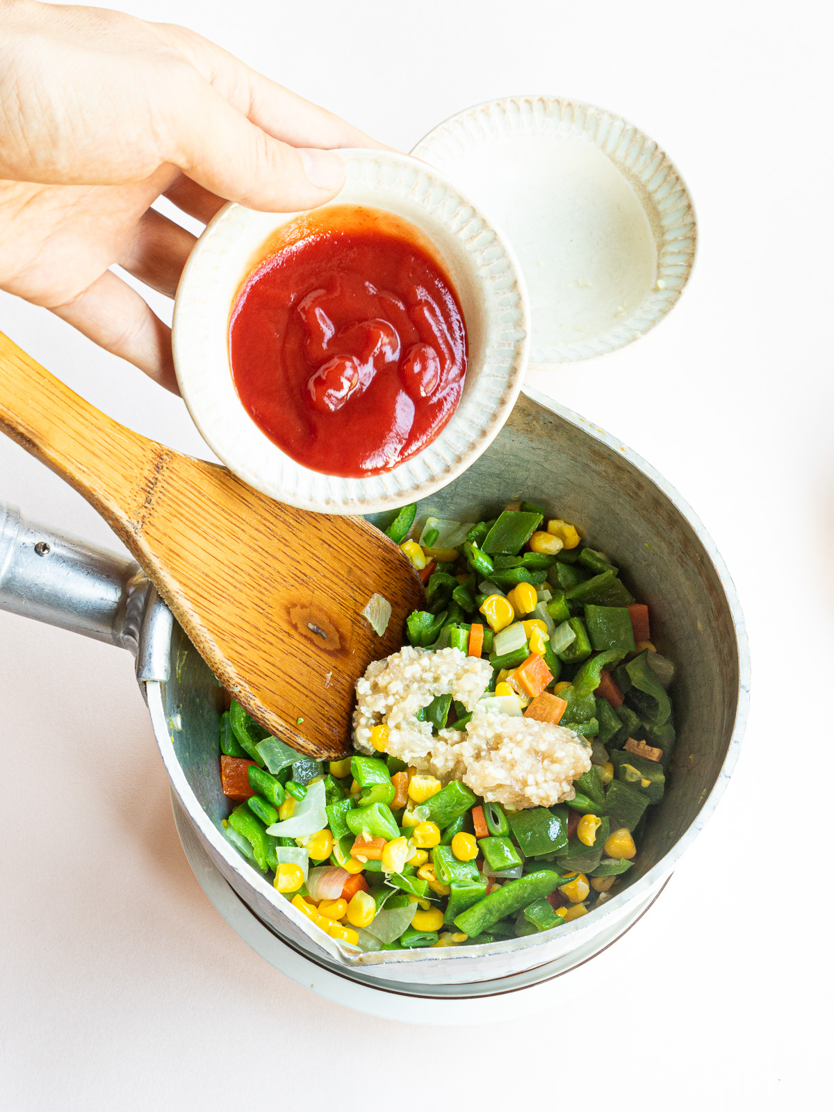 seasonings are added to the stir-fried vegetables.