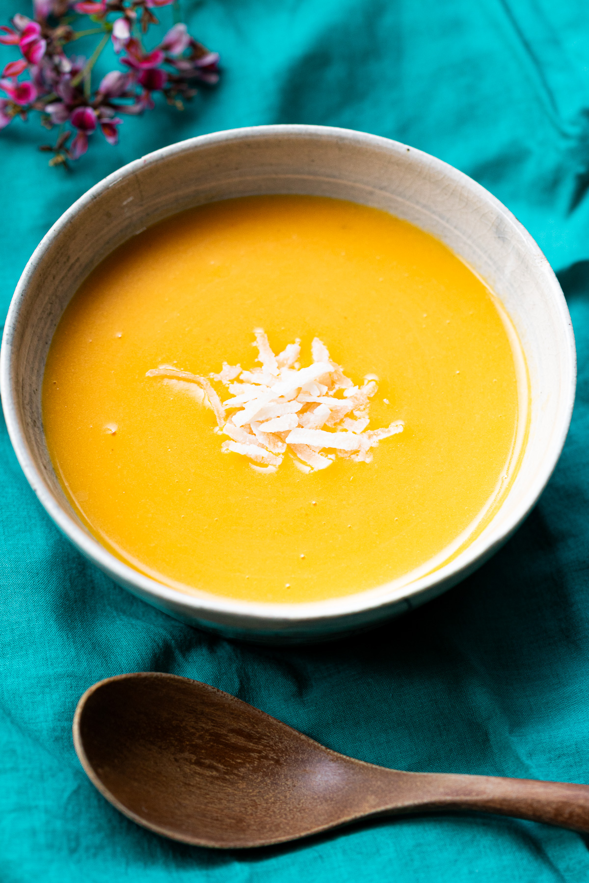 Bright orange vegan pumpkin porridge made with coconut milk — creamy and comforting