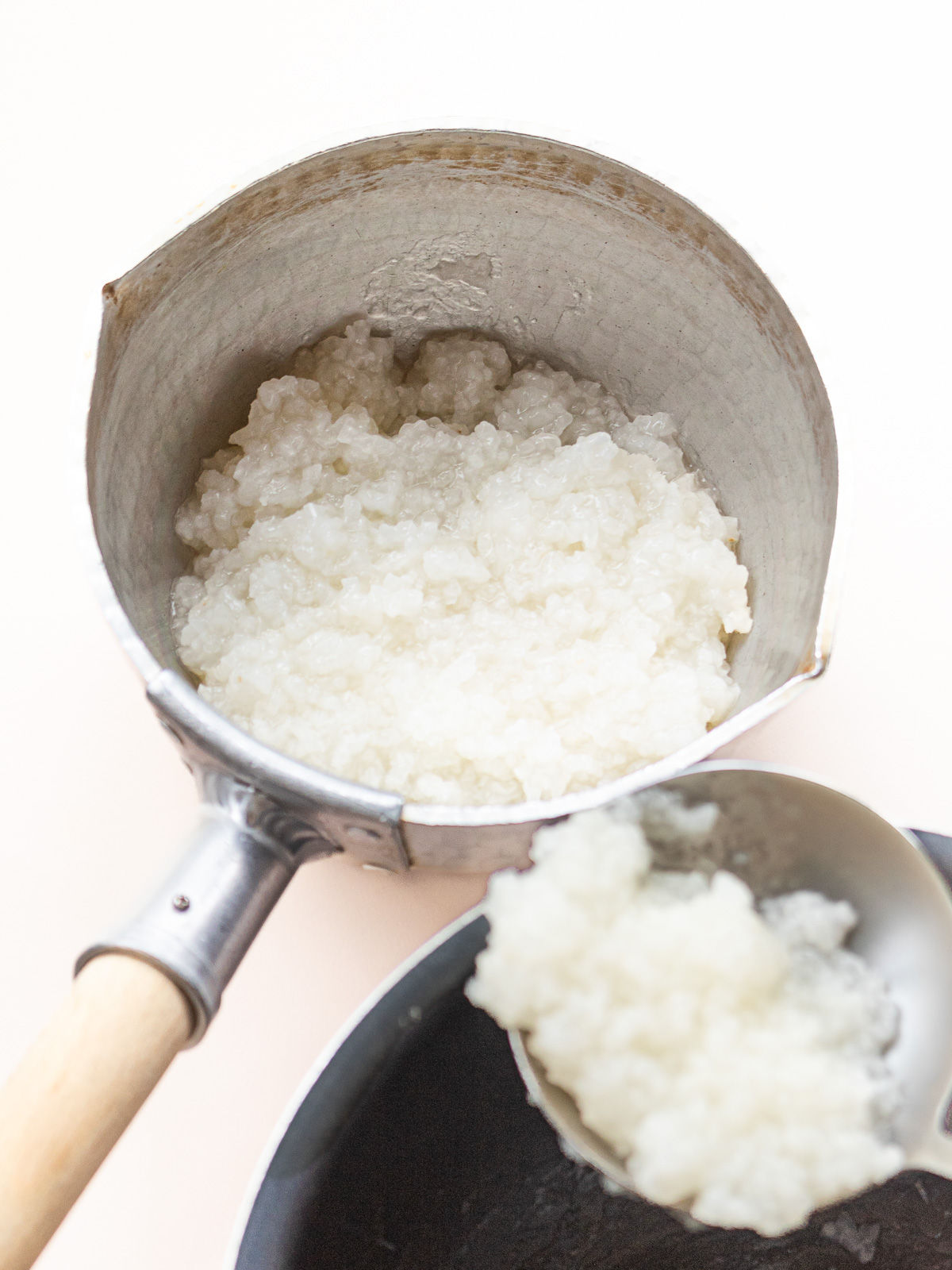 Transferring cooked sticky rice porridge into a pot — for a vegan breakfast base"