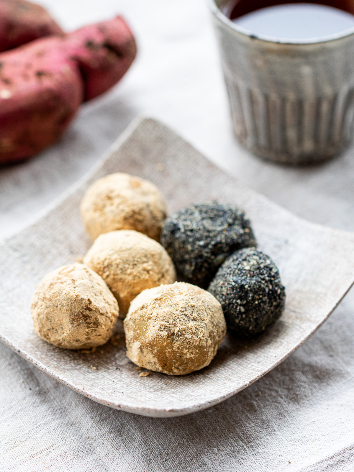 Three varieties of Japanese vegan sweet potato bliss balls - plain kinako, cinnamon, and black sesame