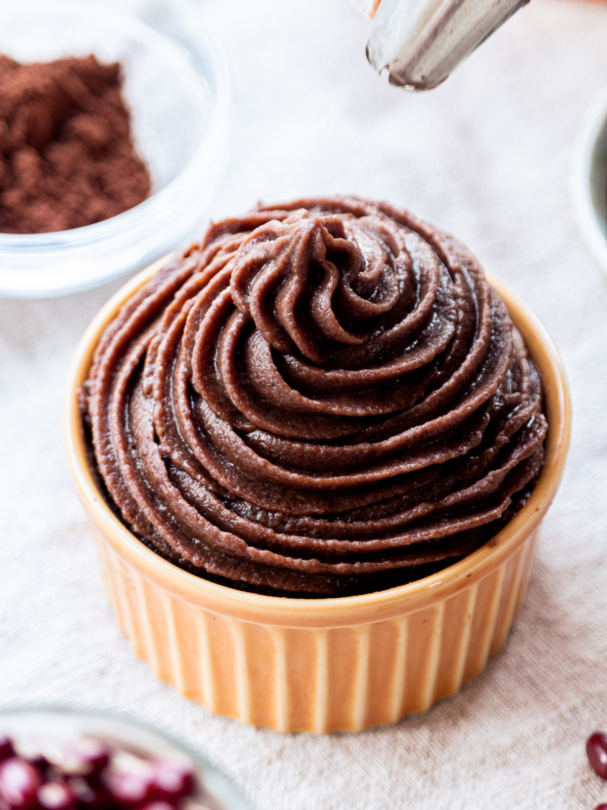 vegan chocolate frosting made with adzuki beans, piped smoothly in a cup, coconut cream-free and soy-free
