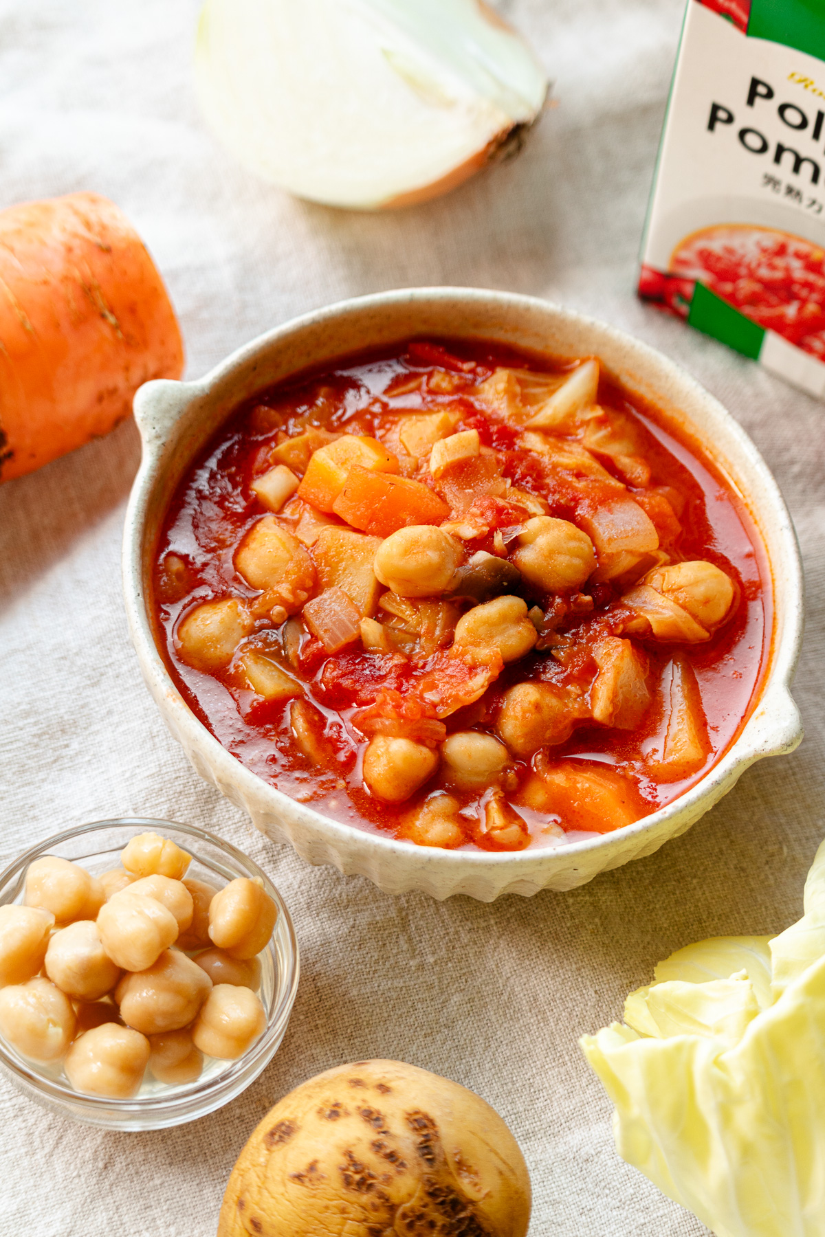 A bowl of chickpea minestrone (vegan pork bean style) and the ingredients used