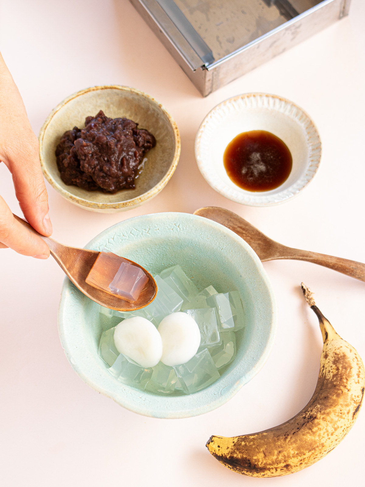 Assembled vegan Shiratama Anmitsu with kuromitsu, bananas, and anko in a serving bowl