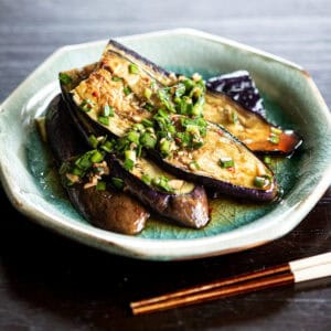 Pan-seared eggplant topped with garlic chive and ginger marinade – a simple vegan summer side dish with maesil syrup.