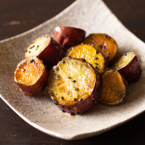 Oven-baked candied sweet potatoes (daigaku-imo) coated in sweet-savory glaze with black sesame seeds