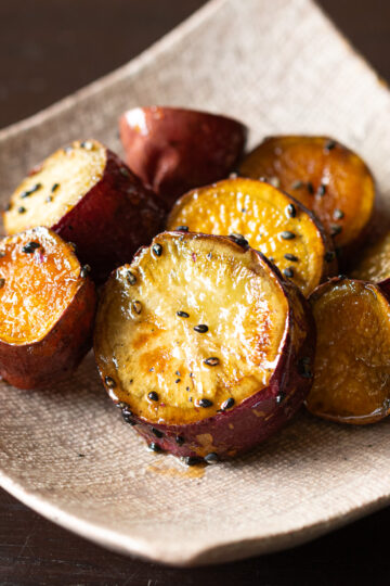 Oven-baked candied sweet potatoes (daigaku-imo) coated in sweet-savory glaze with black sesame seeds