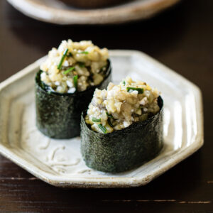 Vegan eggplant gunkan sushi with shio koji topping arranged on white plate, Japanese plant-based sushi recipe