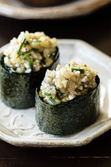 Vegan eggplant gunkan sushi with shio koji topping arranged on white plate, Japanese plant-based sushi recipe