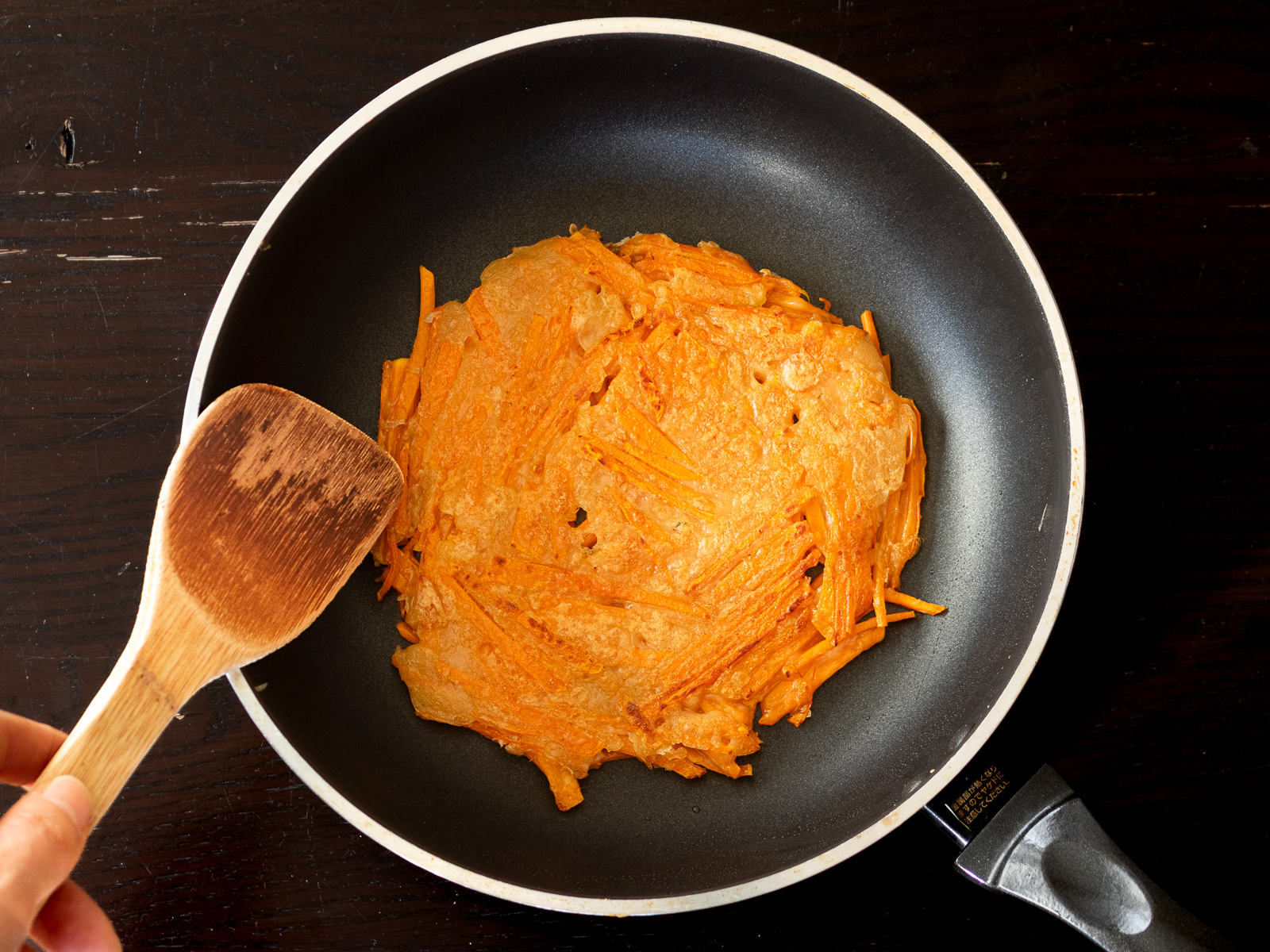 Flipping butternut squash Korean pancake to cook both sides until golden and lightly crisp