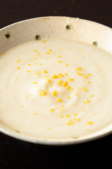 Bowl of creamy vegan turnip soup with yuzu zest, ready to serve