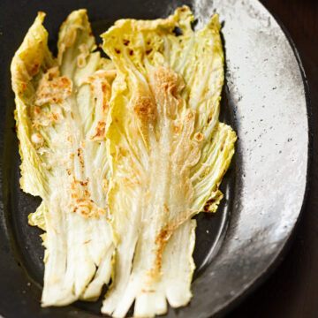 Vegan Korean cabbage pancake (Baechu Jeon) on a plate, golden and crispy, ready to serve as a cabbage side dish