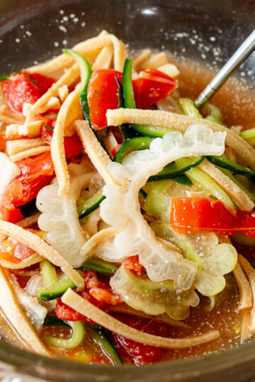 Bitter melon salad with som tam inspired ume vinegar dressing, served with sliced koya tofu to absorb the excess liquid