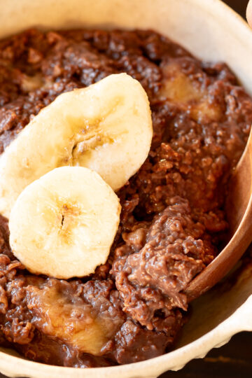 A bowl of creamy chocolate banana oatmeal porridge
