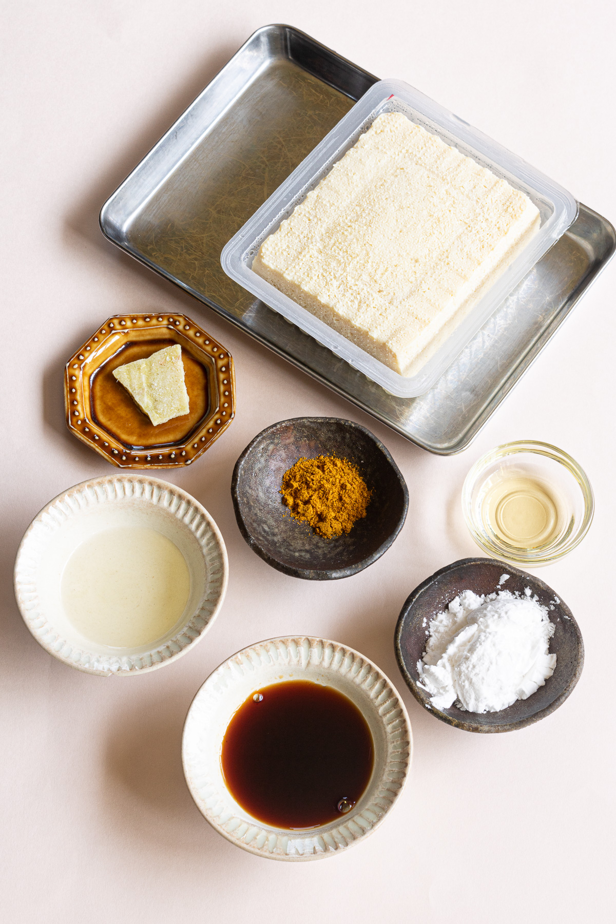 Frozen firm tofu, mirin, soy sauce, grated ginger, curry powder, potato starch, oil