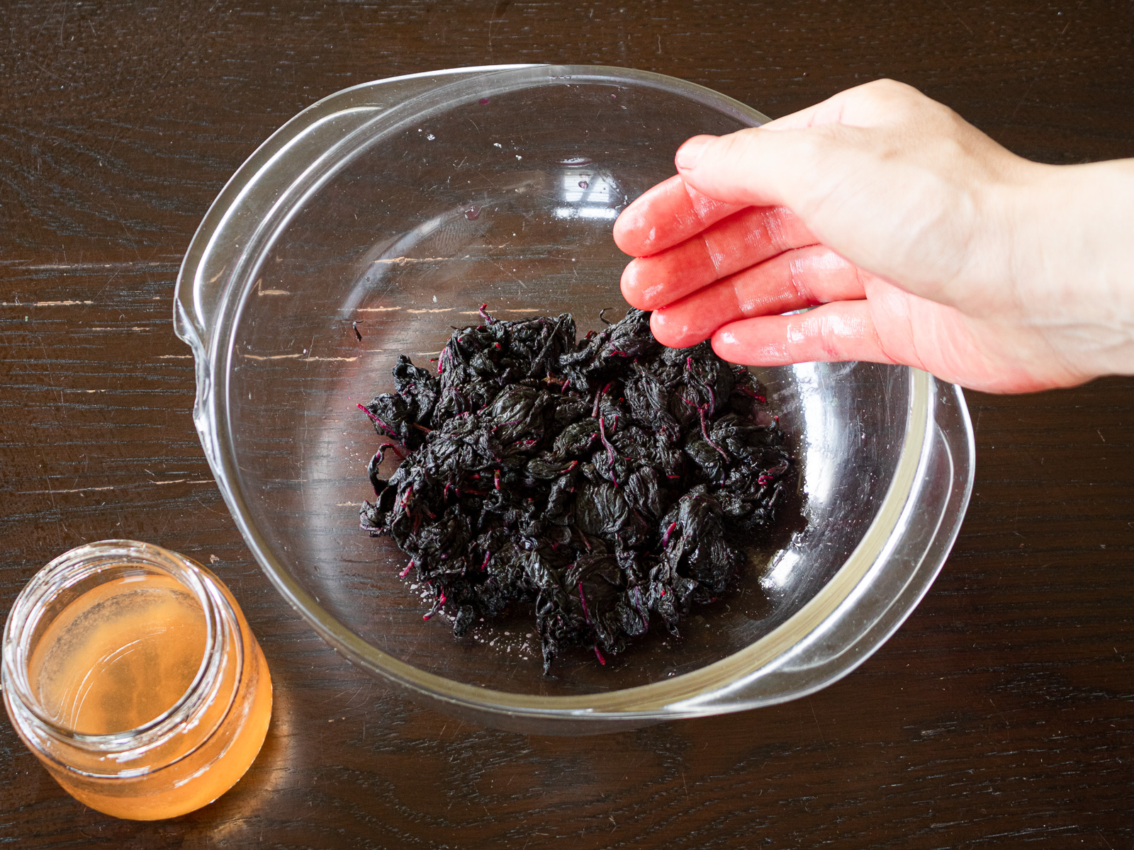 Placing leaves in a container to prevent drying and letting them sit overnight to set the color.
