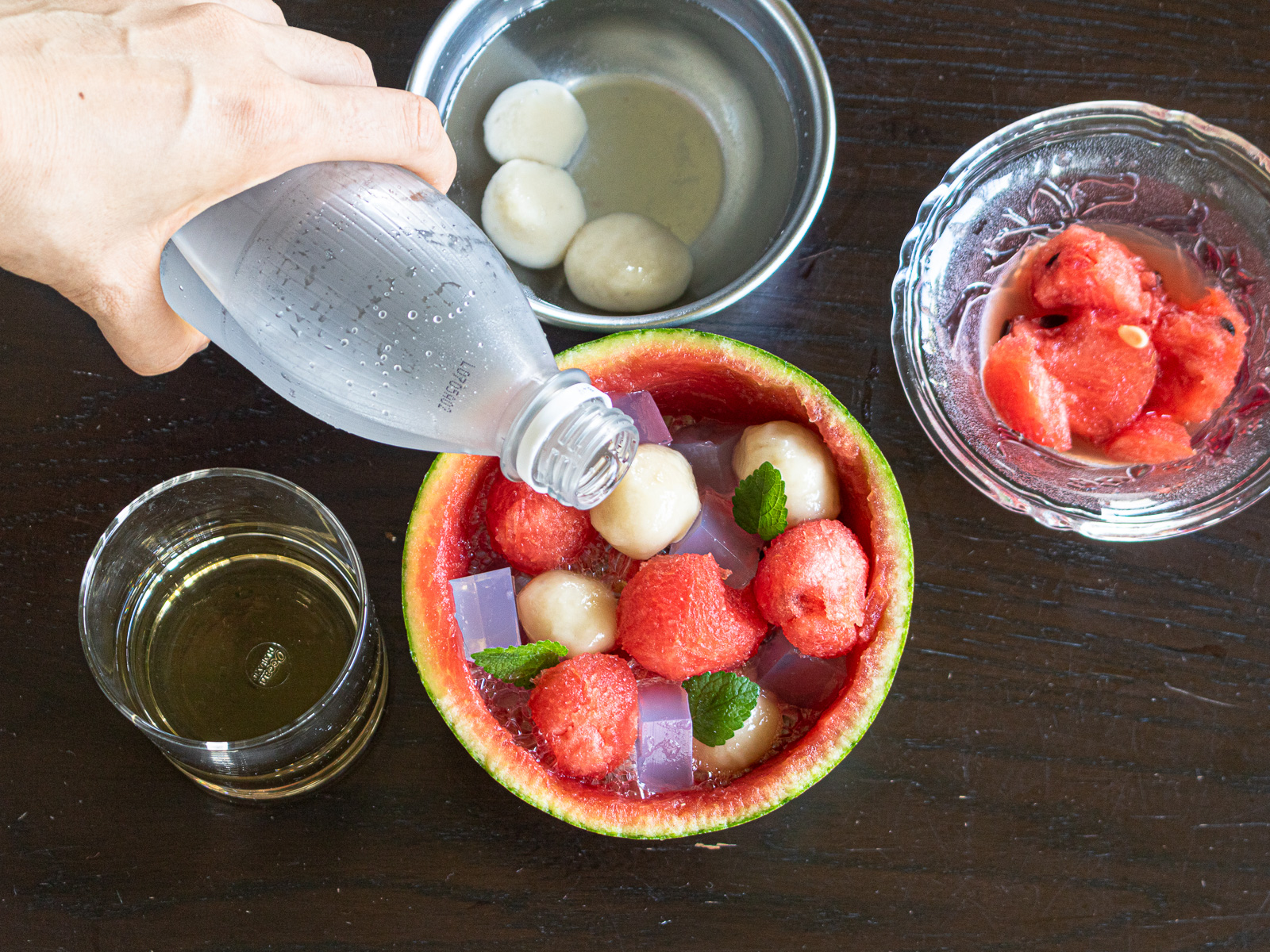 Pour in reserved watermelon juice and simple syrup, top with sparkling water.
