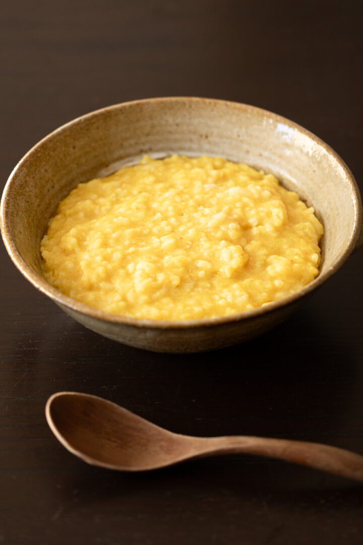Vegan kitchari made with yellow mung beans, a gentle Indian rice porridge often enjoyed as a nourishing breakfast.