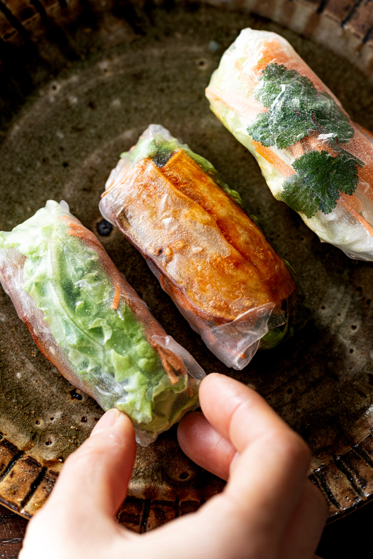 Vegan sweet potato sticks in rice paper rolls with Yangnyeom glaze, a plant-based Korean-inspired snack.