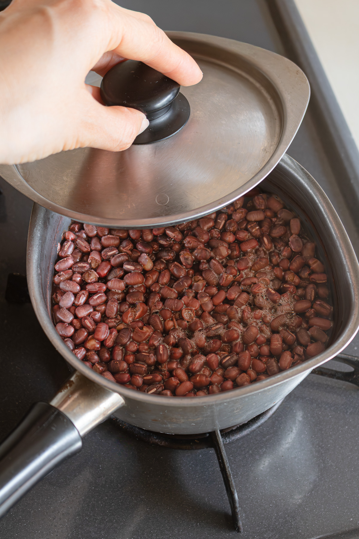 Cooked adzuki beans steaming with the lid on