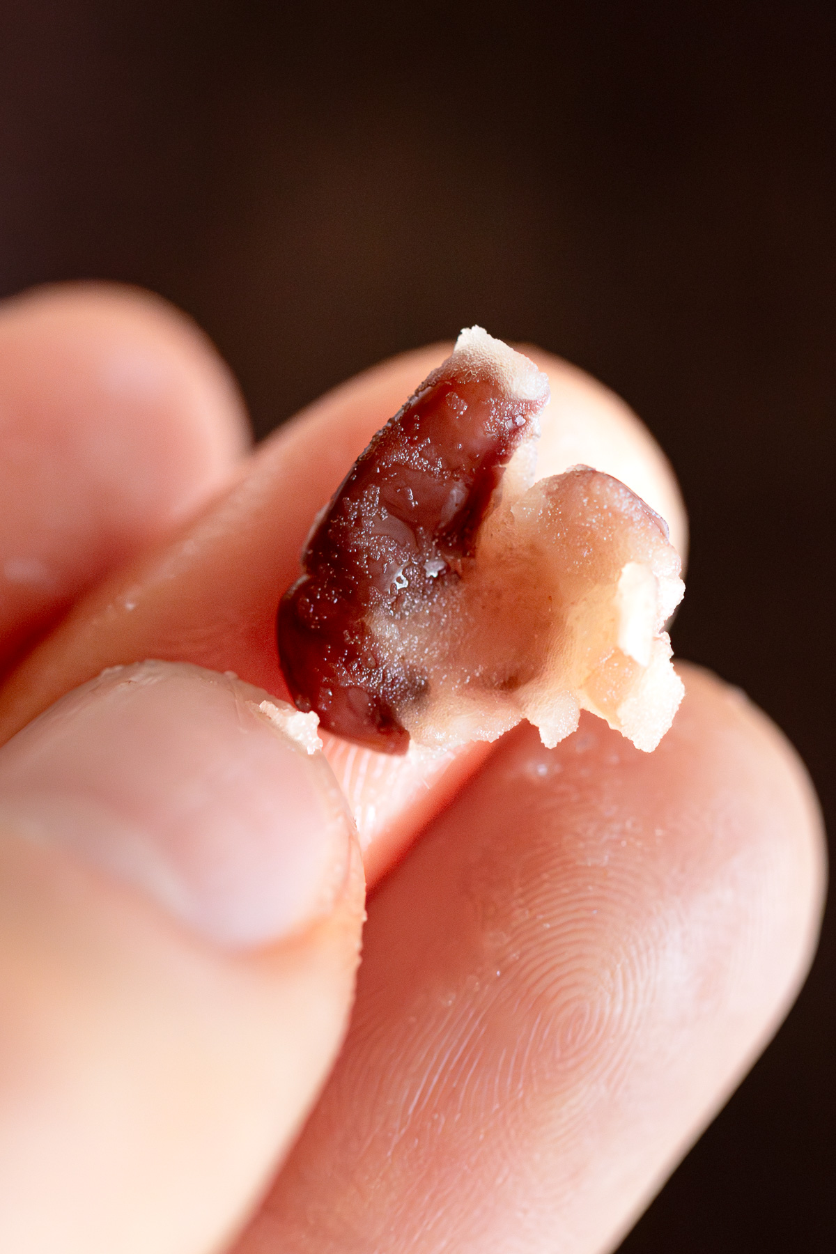 Testing doneness — adzuki bean crushing easily between fingers