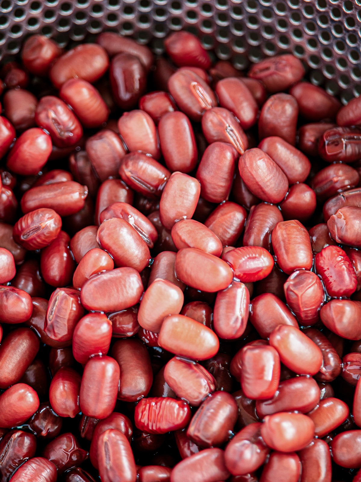 Comparison of adzuki beans — smooth taut skin vs still-wrinkled skin during the plumping stage