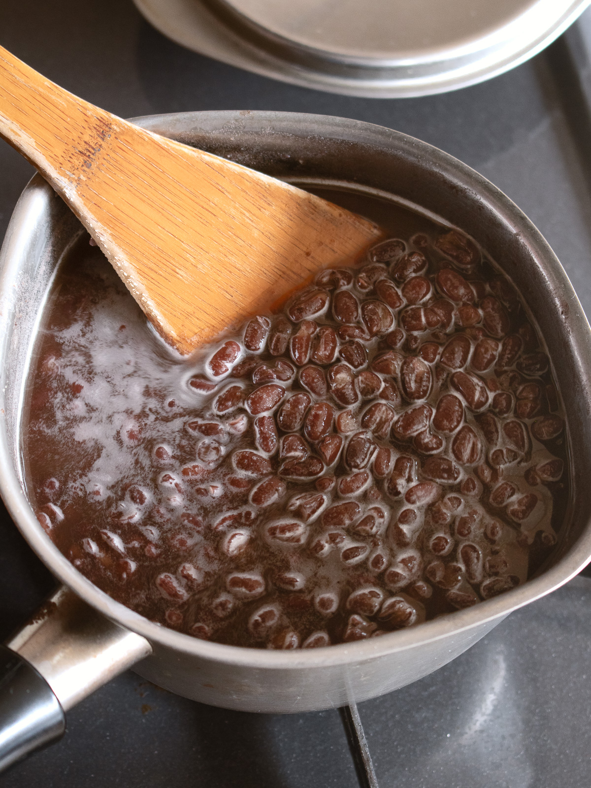 Sugar dissolving into the adzuki beans over heat