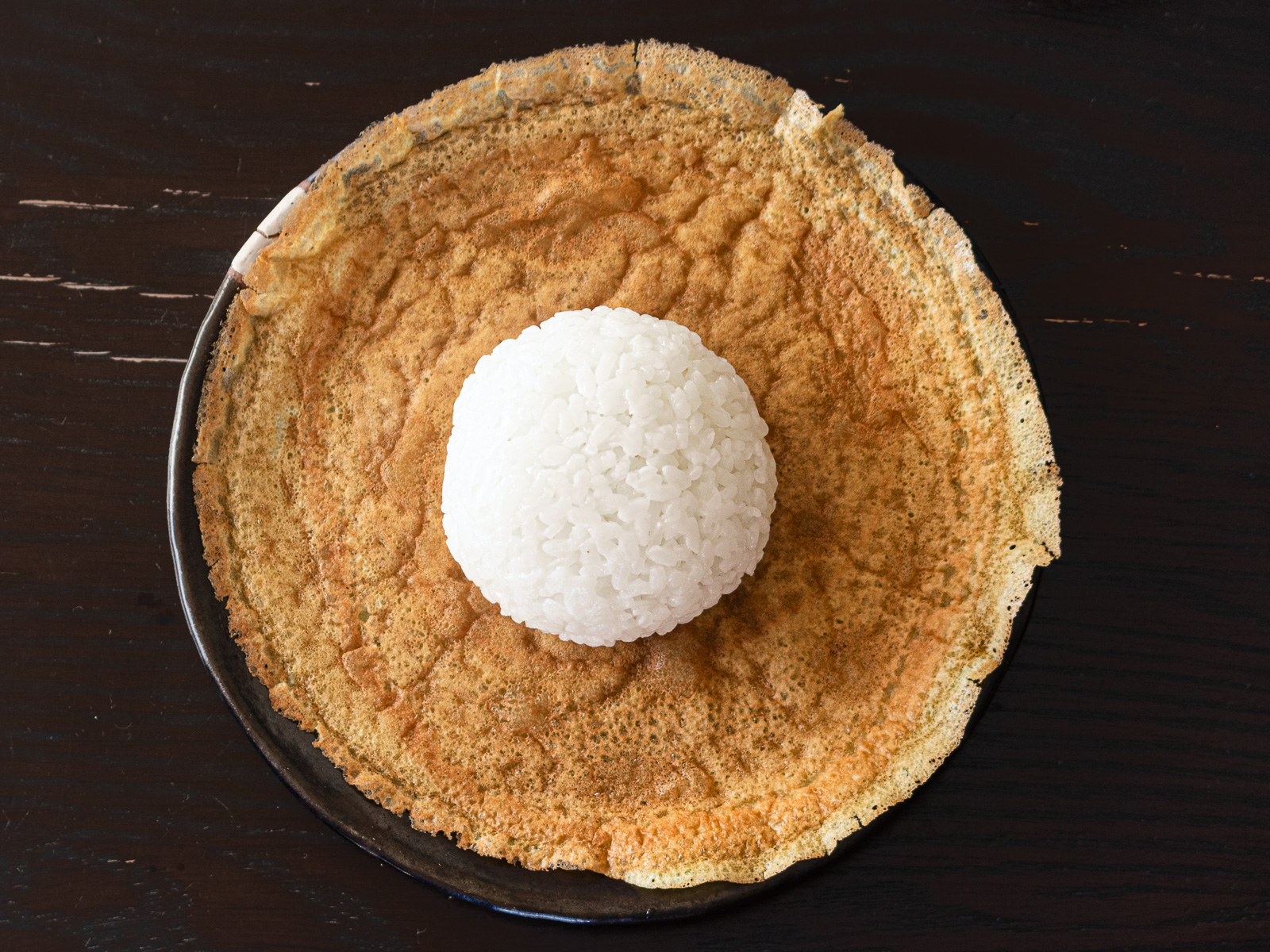 ヴィーガン薄焼き卵の中央に握ったおにぎりを置く｜包み方①